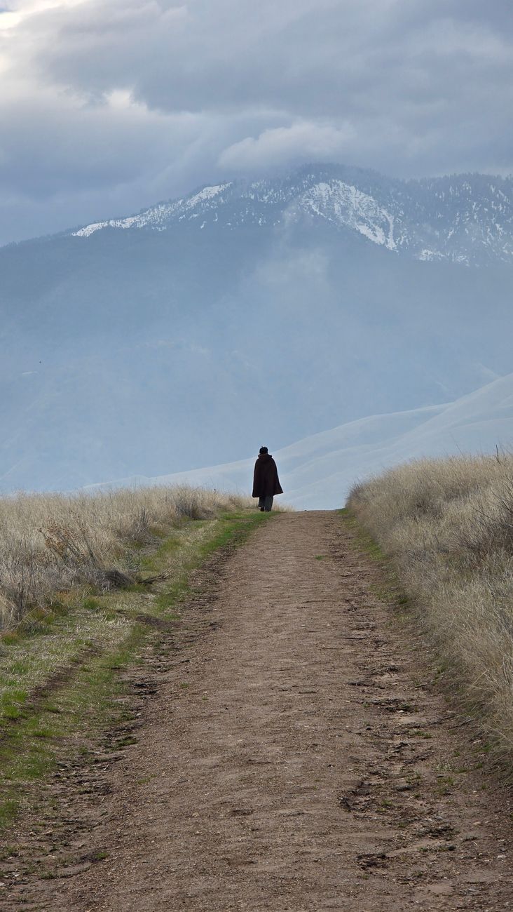 Traveler looking over vast peaceful landscape
